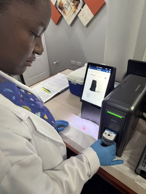 Technologist running a test on a laboratory instrument