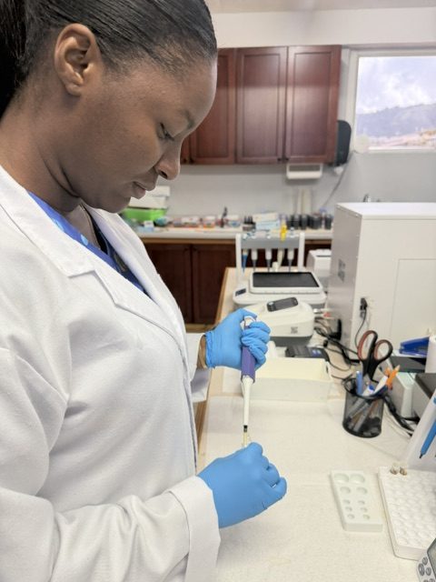Ms. Corahia Adrien, Clinical Laboratory Assistant, pipetting a sample